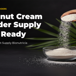 Coconut cream powder cascading from rose gold scoop into glass bowl with coconut and palm leaf accent