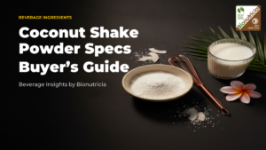 Overhead flat-lay of coconut shake powder with brass whisk and tropical flower on warm surface